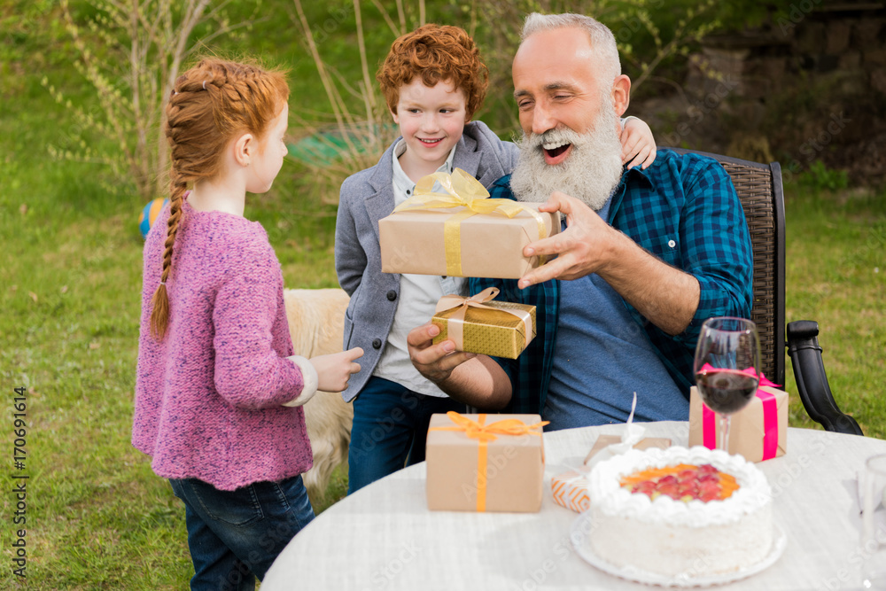 kids greeting grandfather at birthday celebration kids greeting grandfather at birthday celebration