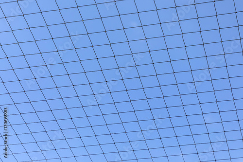 metal net with blue sky