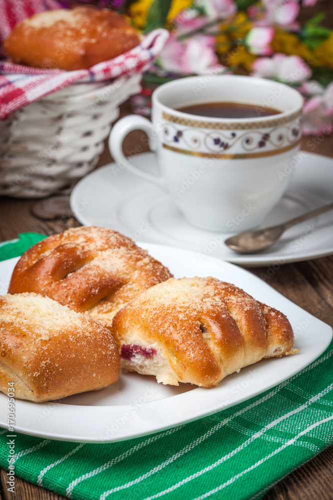 Buns with berries on a wooden table. Buns with berries on a wooden table.