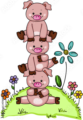 Stack of three little piggies in garden with flowers 