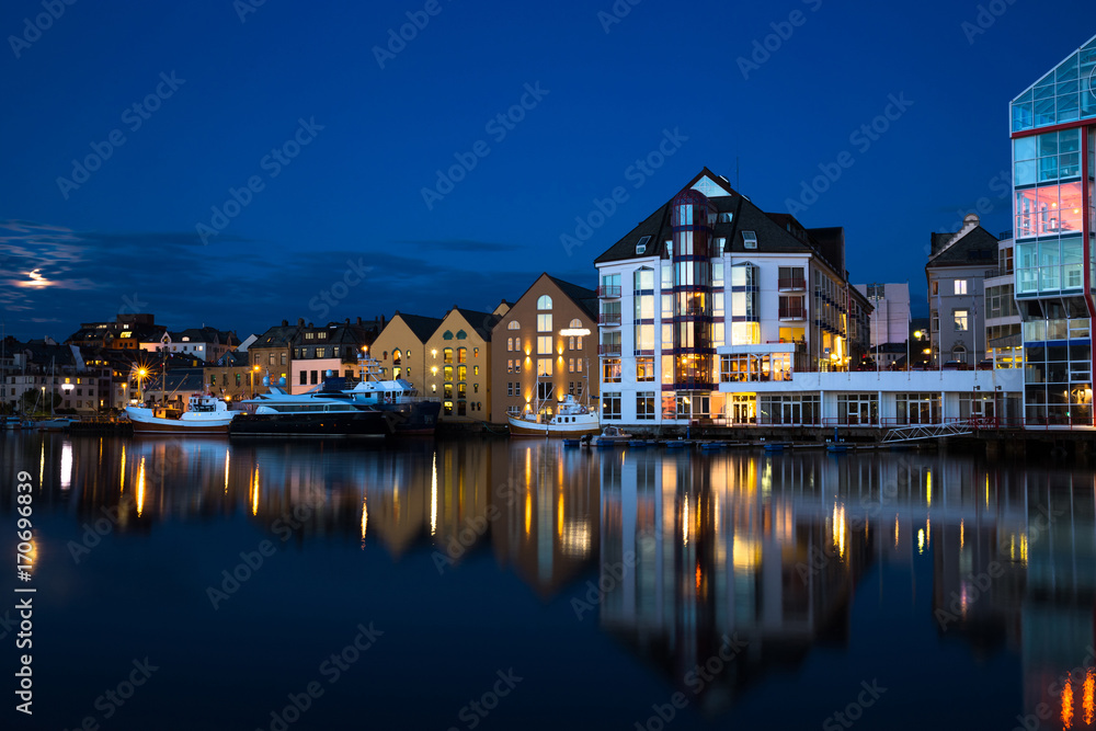 Night view of Alesund. Beautiful lights and reflections in sea. Norway