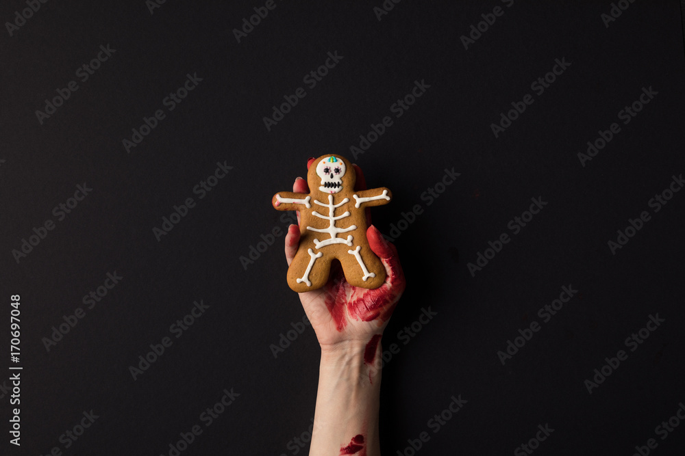 hand holding halloween cookie