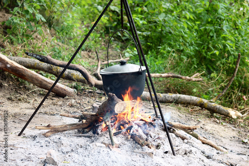 Cooking food in summer on nature at stake in cauldron