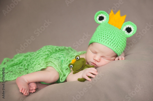 cute newborn baby in a frog costume