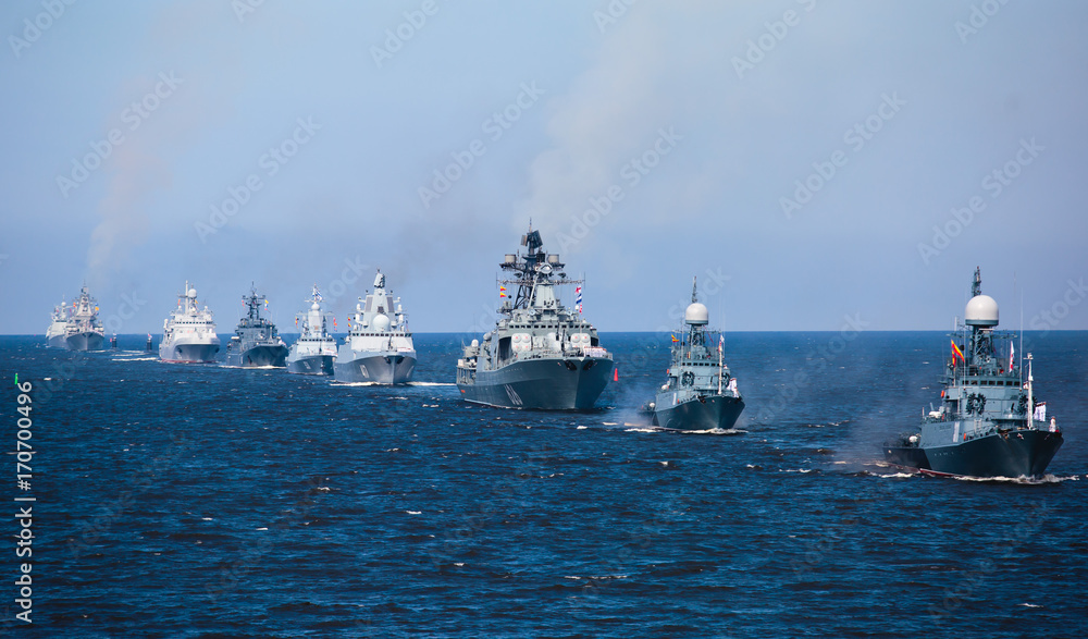 A line of modern russian military naval battleships warships in the row, northern fleet and baltic sea fleet in the open sea