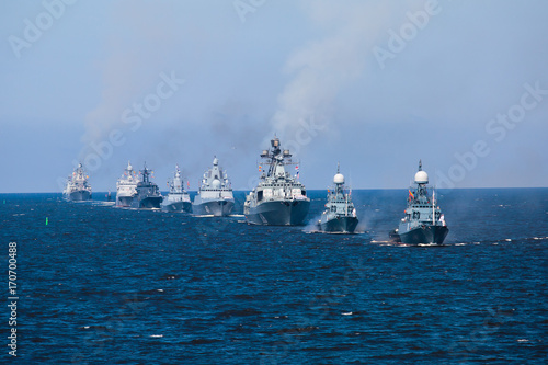 A line of modern russian military naval battleships warships in the row, northern fleet and baltic sea fleet in the open sea photo