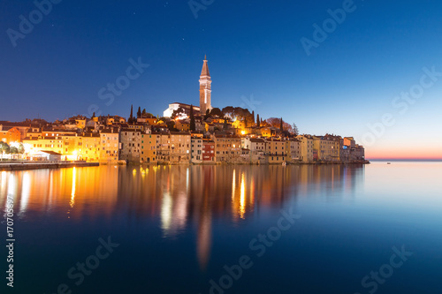 Sunset at medieval town of Rovinj, colorful with houses and church