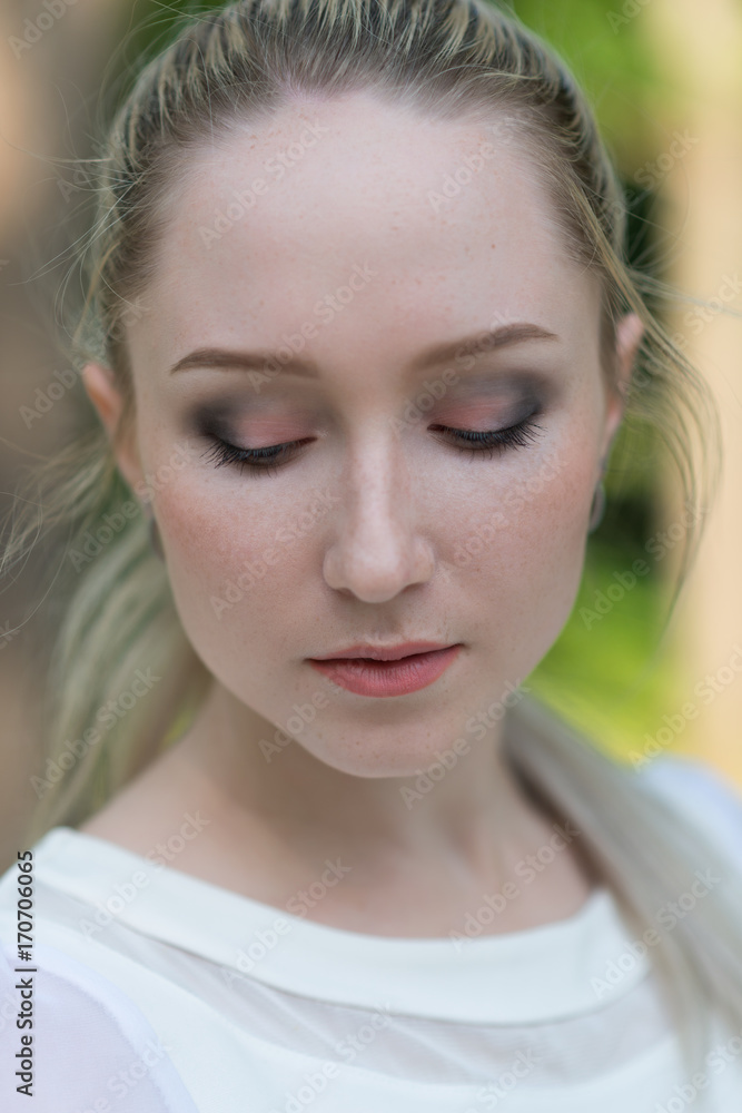 Outdoors portrait of beautiful young woman. Selective focus. Outdoors portrait of beautiful young woman. Selective focus.