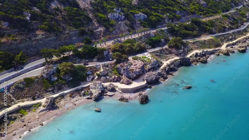 August 2017: Aerial drone video of rocky seascape near famous beach of Ialissos in Rodos town with turquoise waters, Rhodes island, Aegean, Dodecanese, Greece August 2017: Aerial drone video of rocky seascape near famous beach of Ialissos in Rodos town with turquoise waters, Rhodes island, Aegean, Dodecanese, Greece