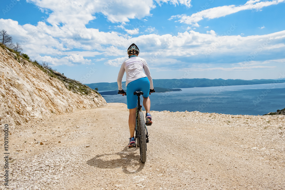 Fototapeta premium Woman biking coast of croatia