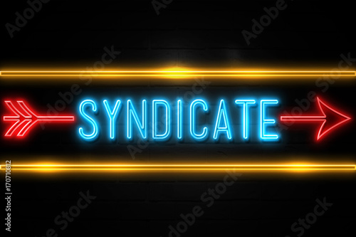 Syndicate  - fluorescent Neon Sign on brickwall Front view