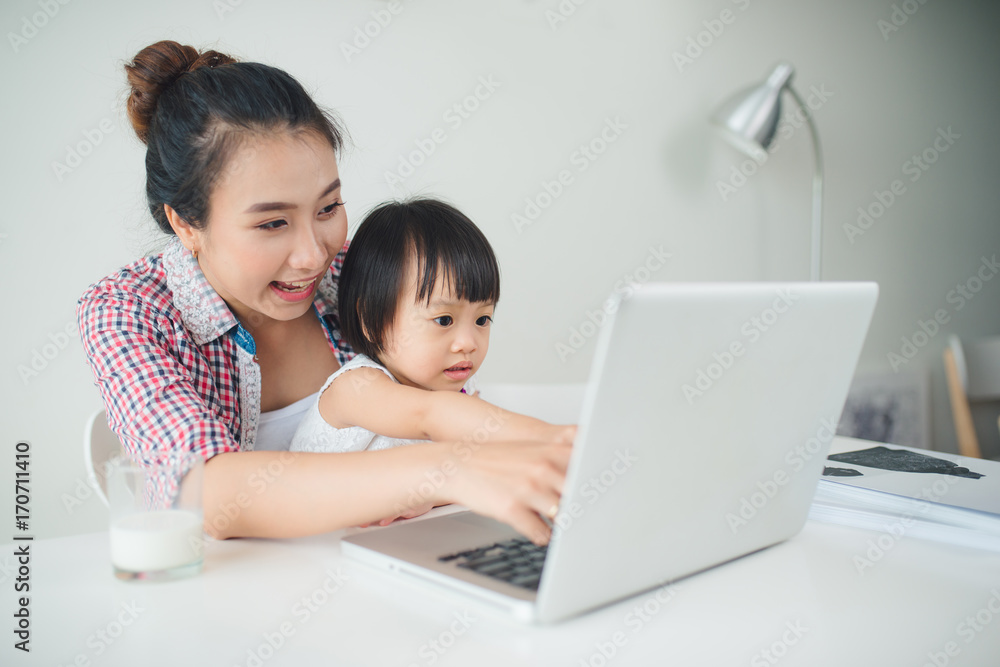 Businesswoman mother woman with a toddler working at the computer Businesswoman mother woman with a toddler working at the computer