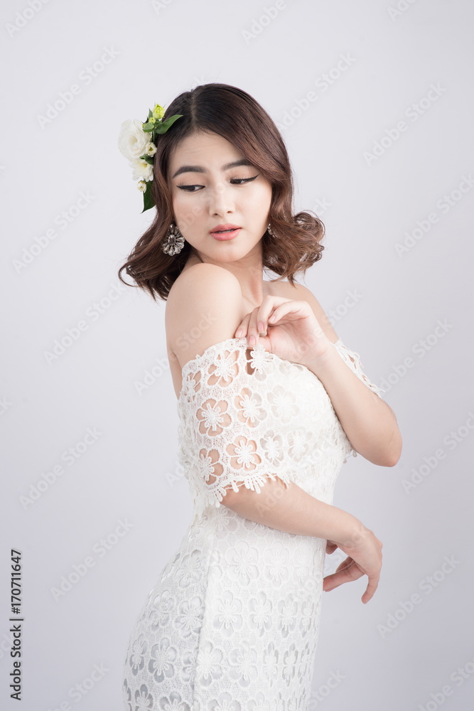 Beautiful asian woman bride on grey background. Closeup portraits with a professional makeup Beautiful asian woman bride on grey background. Closeup portraits with a professional makeup