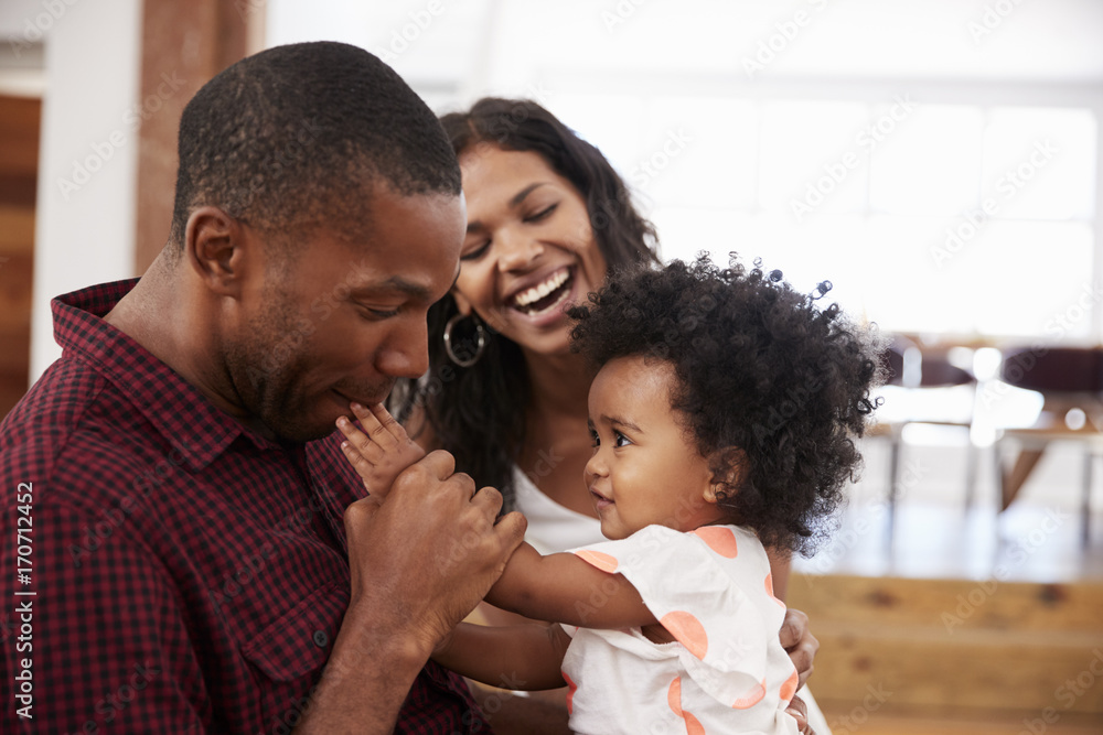 © Monkey Business - Parents Playing With Young Daughter At Home