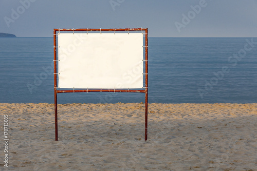 White billboard on a background of blue sea and sky