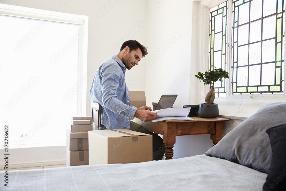 Man In Bedroom Running Business From Home Dispatching Goods Man In Bedroom Running Business From Home Dispatching Goods