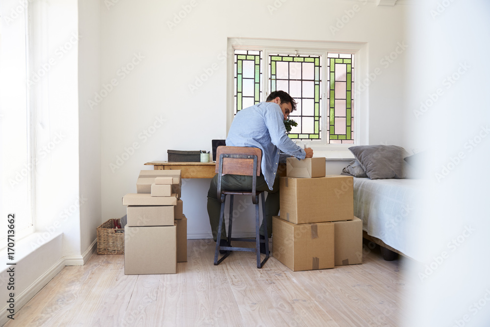 Man In Bedroom Running Business From Home Labeling Goods Man In Bedroom Running Business From Home Labeling Goods