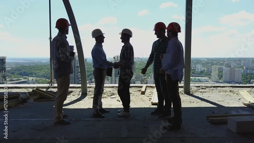 Aerial View Of Builders Team Handshake With Business Man Employer On Construction Site, Meeting Of Group Of Contractors And Engineers With Architects