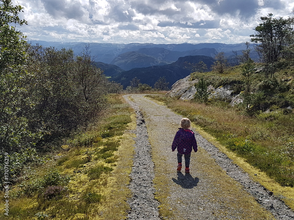Child hiking in Norwegian mountains