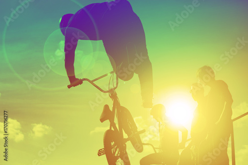 Bikers jumping on a ramp in the park