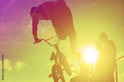 Bikers jumping on a ramp in the park