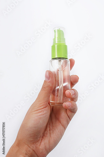 a bottle with a spray in the girl's hand