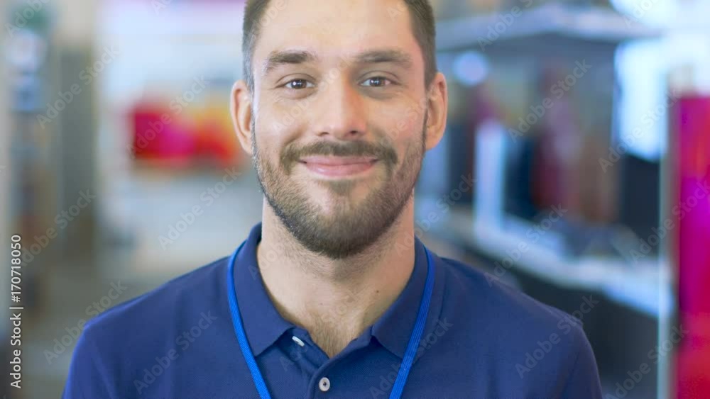 Portrait of a Professional Expert Consultant Smiles and Looks into Camera as Stands in the Bright, Modern Electronics Store. The Depth of Field Shot. Shot on RED EPIC-W 8K Helium Cinema Camera. Portrait of a Professional Expert Consultant Smiles and Looks into Camera as Stands in the Bright, Modern Electronics Store. The Depth of Field Shot. Shot on RED EPIC-W 8K Helium Cinema Camera.