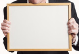 Blank Whiteboard Sign Held Up by Businessman in Suit