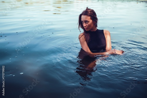 Beautiful sexy woman in black swimsuit at the sea, beautiful tan, sexy mood, amazing slim woman in sexy swimwear © evgeniy_regulyan