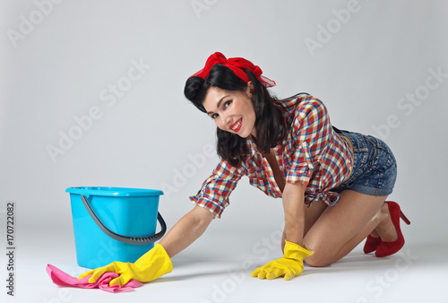 Beautiful woman in rubber gloves .