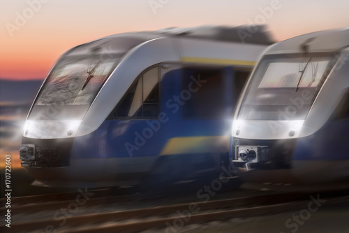 two trains speeding in a sunset