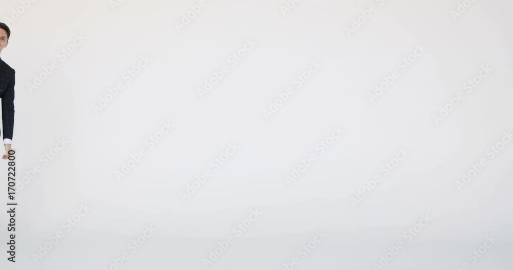 Attractive young businessman is dances on the move . white background Attractive young businessman is dances on the move . white background