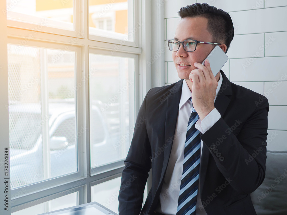Portrait of a smiling young business man using smartphone Portrait of a smiling young business man using smartphone