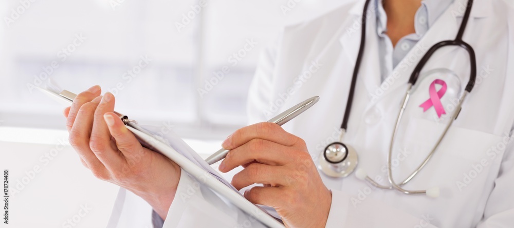 Composite image of mid section of a female doctor writing Composite image of mid section of a female doctor writing
