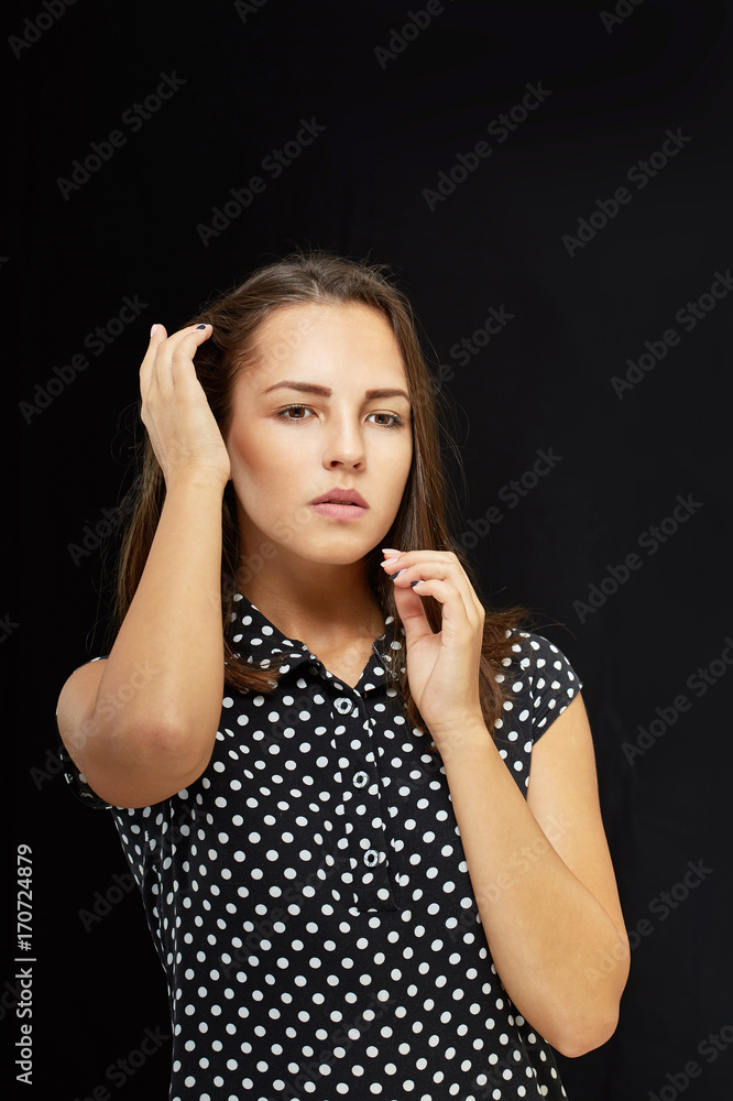 The girl is dressed in a polka-dot dress