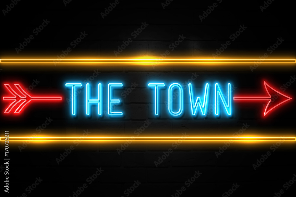 Obraz premium The Town - fluorescent Neon Sign on brickwall Front view