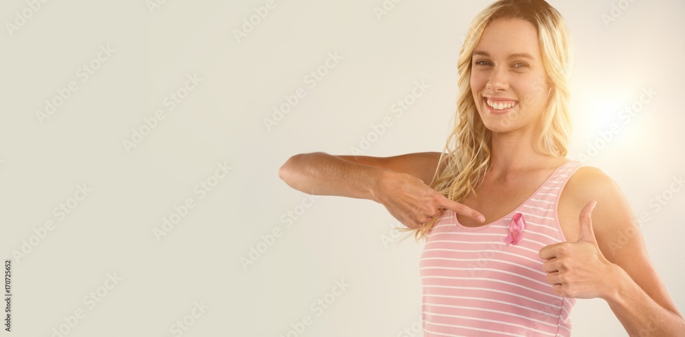 Portrait of woman showing thumbs up while pointing on pink Portrait of woman showing thumbs up while pointing on pink