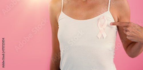 Mid section of young woman pointing at ribbon
