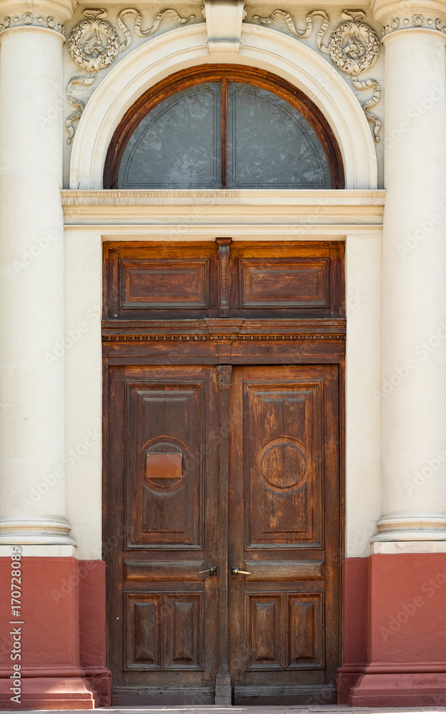 The door of the old European building. Exterior design element of ancient Lvov. Example of world architectural heritage. The door of the old European building. Exterior design element of ancient Lvov. Example of world architectural heritage.