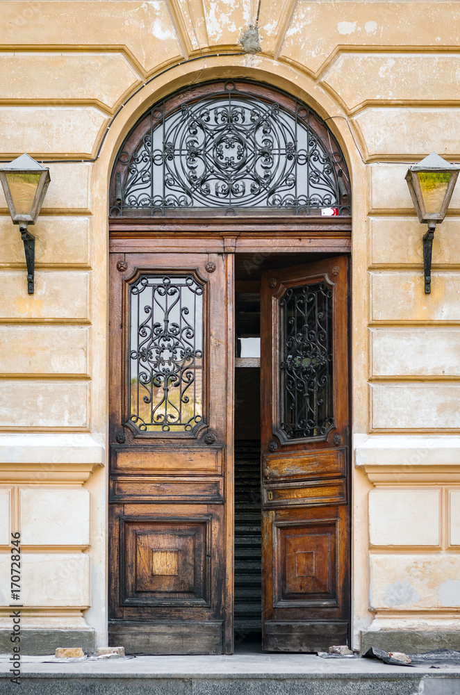 The door of the old European building. Exterior design element of ancient Lvov. Example of world architectural heritage. The door of the old European building. Exterior design element of ancient Lvov. Example of world architectural heritage.