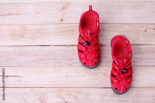 Red shoes sandle isolated on a wooden background