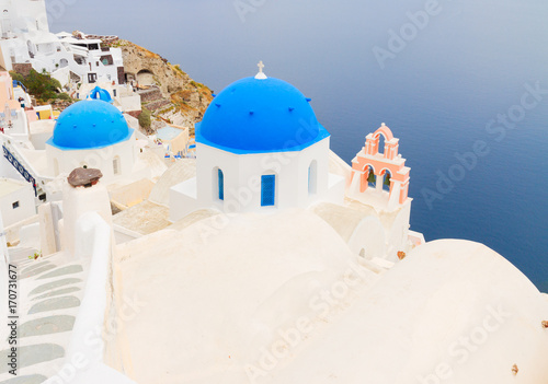 view of Aegan sea with blue church domes and towerbell, Oia, Santorini