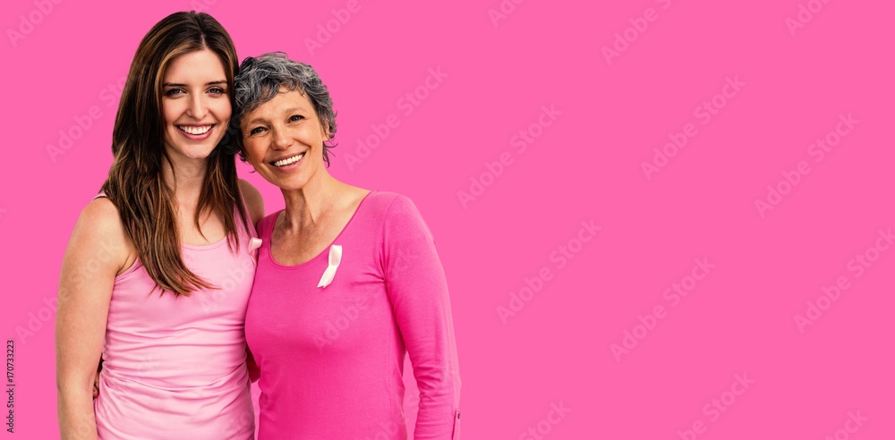 Composite image of smiling women in pink outfits posing for Composite image of smiling women in pink outfits posing for