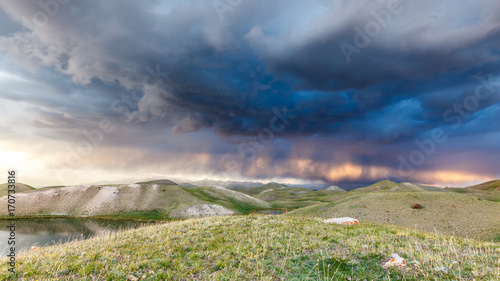 View of Tulpar Kul lake in Kyrgyzstan during the storm photo