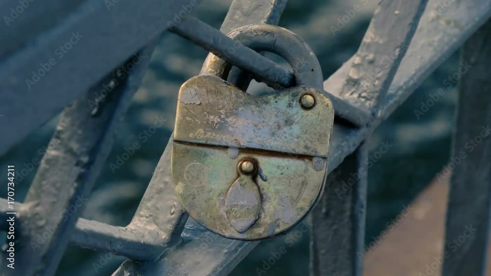 One wedding lock hanging on bridge railings left by enamored newlyweds. 4K One wedding lock hanging on bridge railings left by enamored newlyweds. 4K