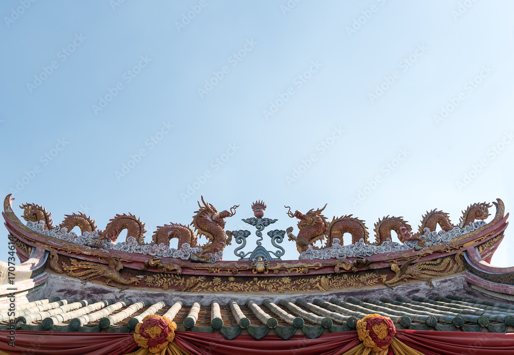 Grunge old Two dragons on the Chinese temple old rooftop with blue sky. Grunge old Two dragons on the Chinese temple old rooftop with blue sky.