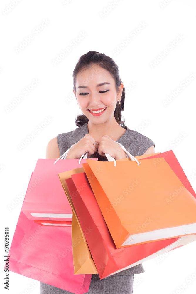 Cheerful shopping woman of Asian holding bags. Shopping smart business woman happy smiling holding colorful shopping bags isolated on white . Fresh young Asian female model Cheerful shopping woman of Asian holding bags. Shopping smart business woman happy smiling holding colorful shopping bags isolated on white . Fresh young Asian female model