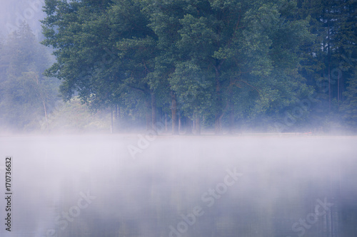 Lake at foggy morning misty weather