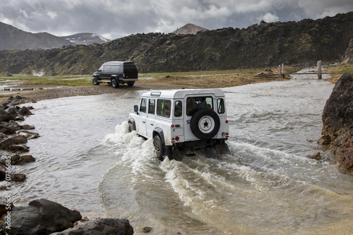 Принти на полотні two vehicles fording river in nature park  landmannalaugar in iceland