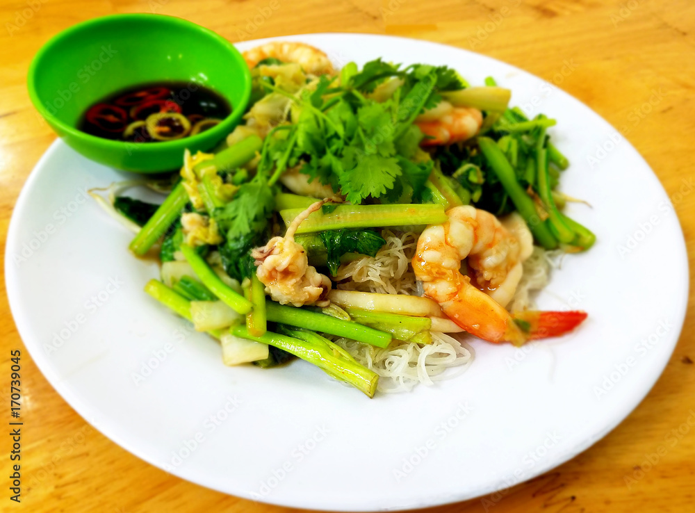 Stir fired rice noodles with seafood. Stir fired rice noodles with seafood.
